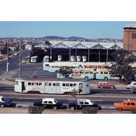 Wide shot of Annerley depot with tram No. 502 and a fleet of buses and other trams - 1968