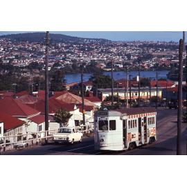 Landscape shot of tram No. 406 on Gladstone Road possibly near Beaconsfield Street, Highgate Hill - 1969
