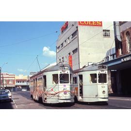 Tram No. 412 painted with flowers and covered with ribbons with No. 531 on Warner Street, Fortitude Valley - 1969