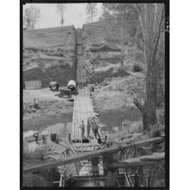 Man laying Ashgrove sewerage main underground -1953