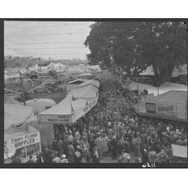 Crowds at rides, games, bar and stalls in Exhibition (Ekka) grounds - 1950