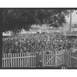 Crowd behind fence at Exhibition (Ekka) grounds - 1950