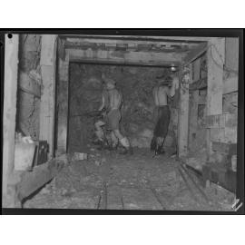 Workers tunneling under Riding Road Balmoral for sewerage line construction - 1949