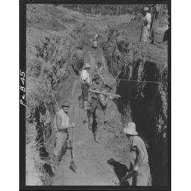 Workers excavating sewerage line with picks and shovels - 1949