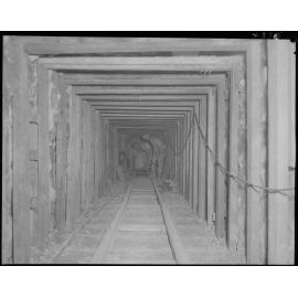 Two men in underground tunnel, Eagle Farm pipeline for pump station -1953