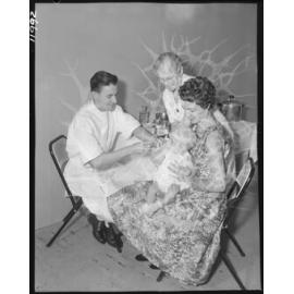 Baby being vaccinated at City Hall immunisation centre, Brisbane City - 1959