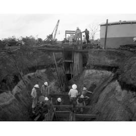 Workers in stages of constructing sewerage main, Nudgee Road, Northgate- 1963