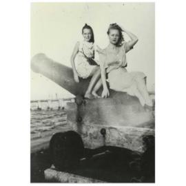 Girl and woman on cannon on Wynnum beachfront, 1930s